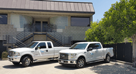 Flow N Control's Trucks Outside of Building